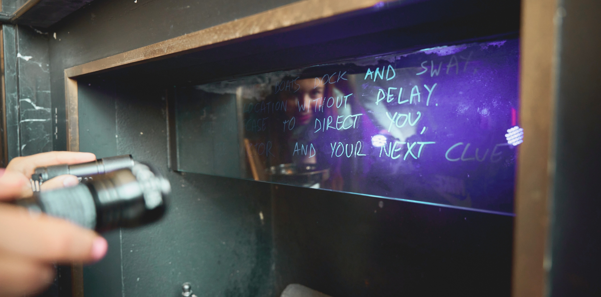 UV light shining on a mirror to reveal some writing